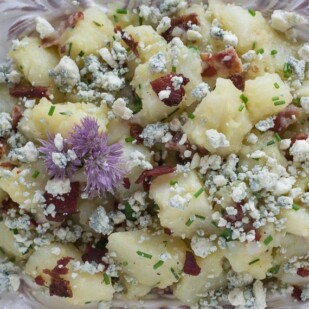 closeup image of Potato Salad with Bacon, Chives & Blue Cheese in decorative white bowl