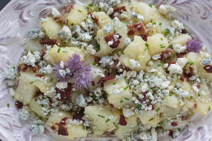 closeup image of Potato Salad with Bacon, Chives & Blue Cheese in decorative white bowl