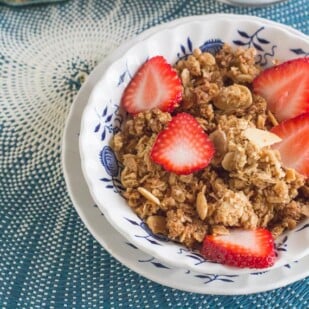 gingersnap granola in blue and white bowl on blue placemat