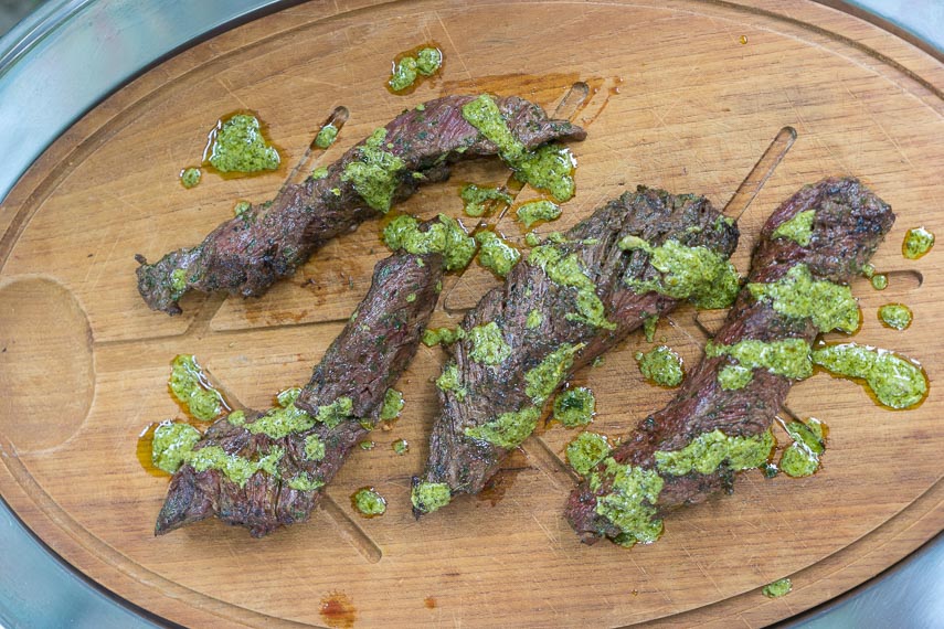 grilled hanger steak with Charmoula sauce on cutting board