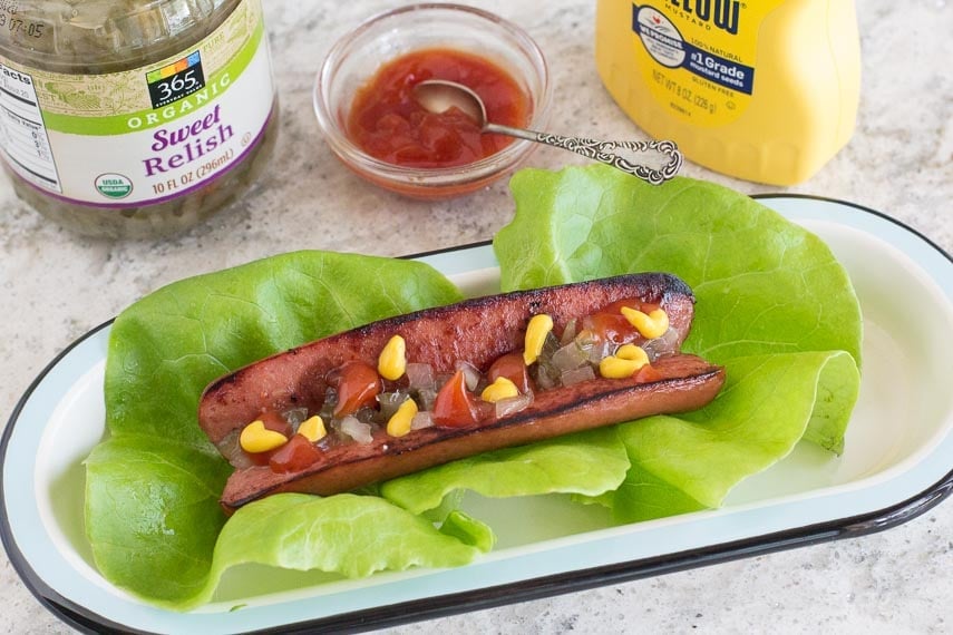 hot dog, split and grilled and wrapped in lettuce