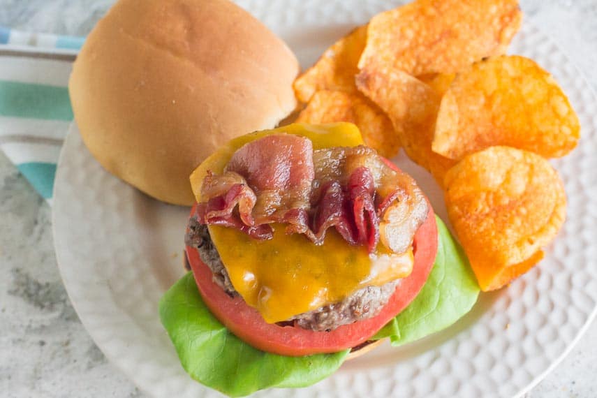 our best Low FODMAP burger on a white plate with potato chips