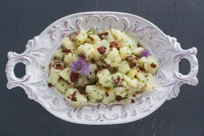 overhead image of Potato Salad with Bacon, Chives & Blue Cheese in decorative white bowl