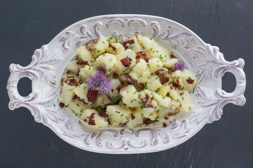 overhead image of Potato Salad with Bacon, Chives & Blue Cheese in decorative white bowl
