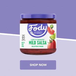 Fody container of mild salsa with images of sliced tomatoes, jalapeños, and limes on a purple background