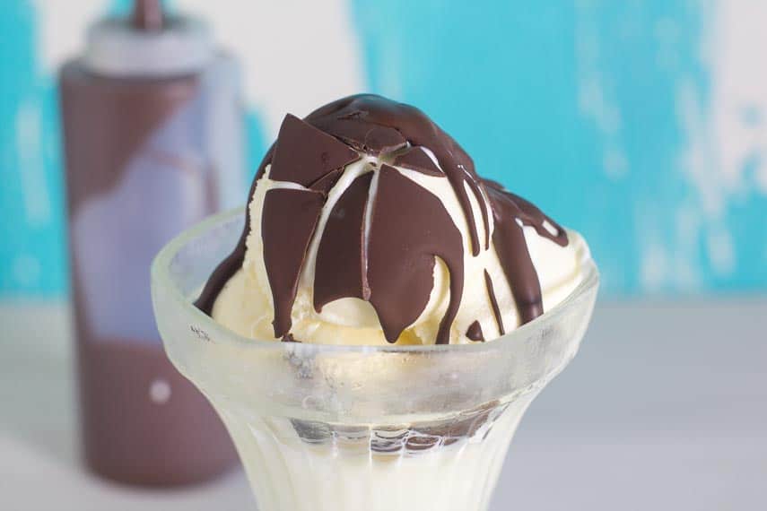 chocolate shell, shattered on vanilla ice cream in glass dish