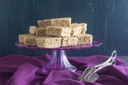 cappuccino rice crispy treats on purple pedestal with silver serving implement alongside