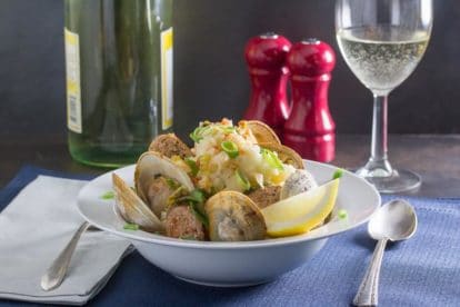 roast clams and sausage with mashed potatoes in white bowl
