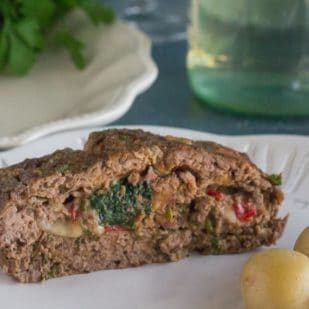closeup of stuffed meatloaf on white plate