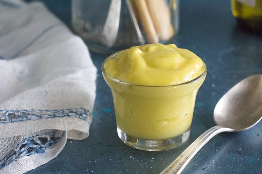 creamy aioli garlicky mayonnaise in small glass bowl with spoon