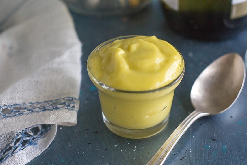 creamy aioli garlicky mayonnaise in small glass bowl with spoon