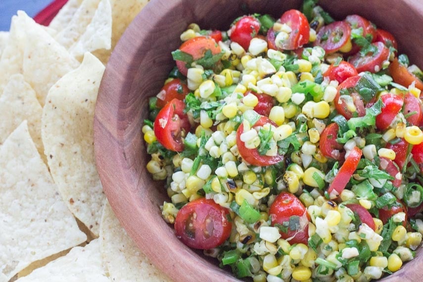 grilled corn salsa in wooden bowl with side of corn chips