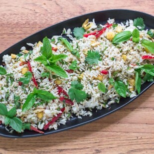 low FODMAP coconut rice salad on a black oval plate