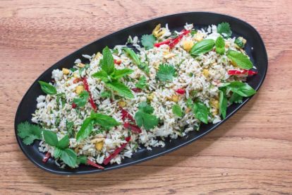 low FODMAP coconut rice salad on a black oval plate