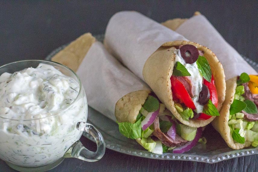 low FODMAP lamb gyros with feta tzatziki piled on a plate