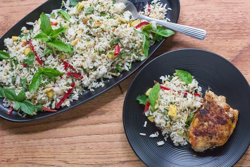 low fodmap coconut rice salad plated with roasted chicken