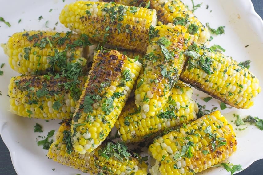 overhead image of low FODMAP grilled corn with garlic herb butter