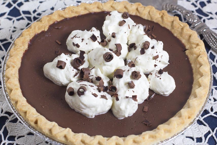whole low FODMAP chocolate pudding pie on a lace tablecloth