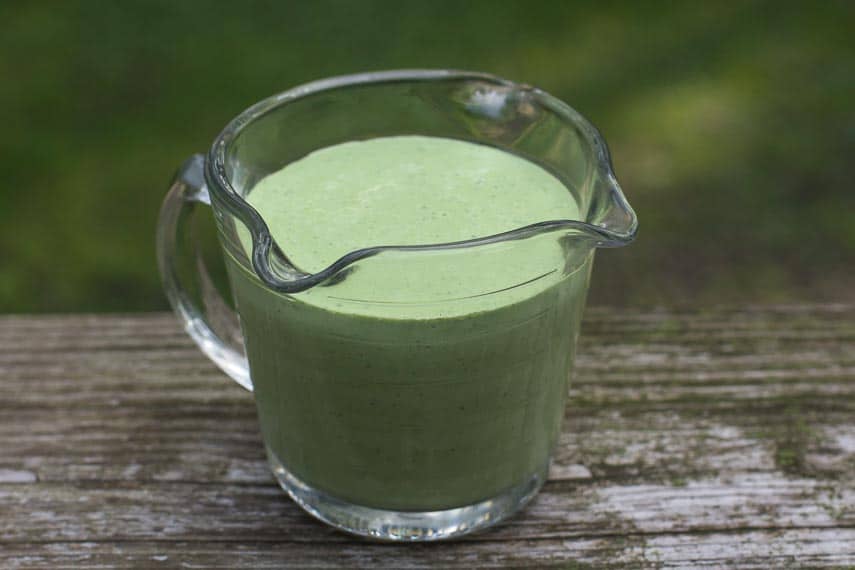Low FODMAP Green Goddess dressing in a measuring cup