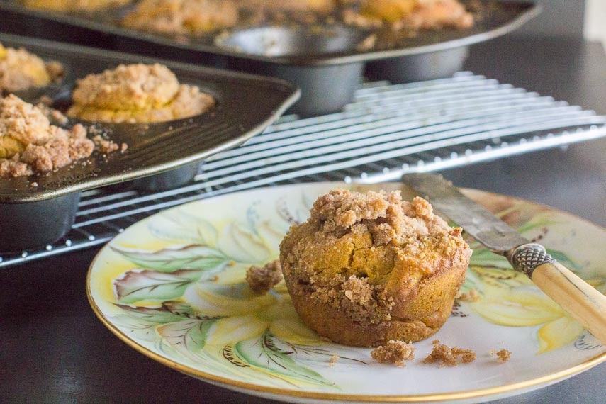 closeup of low FODMAP dairy free gluten free pumpkin streusel muffin on decorative plate with knife