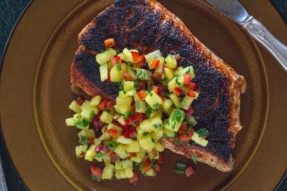 Blackened Salmon with low FODMAP sweet & spicy dry rub and low FODMAP pineapple salsa on a brown plate