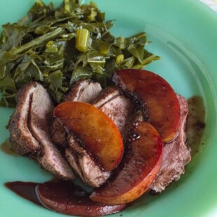 Low FODMAP Duck Breasts with Peaches & Red Wine closeup on green plate