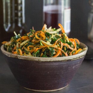 Low FODMAP Kale, Carrot & Apple Salad in a ceramic bowl