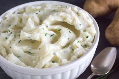 Low FODMAP Sour Cream & Chive Mashed Potatoes in a white Bowl