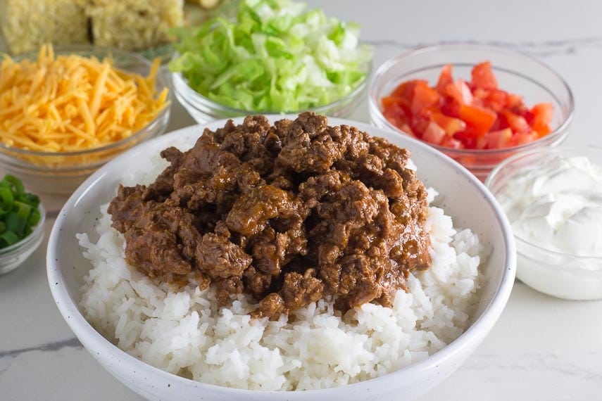 Low FODMAP all beef chili closeup on rice in white bowl