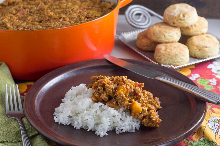 low FODMAP vegan tempeh chili with butternut squash on brown plate with rice