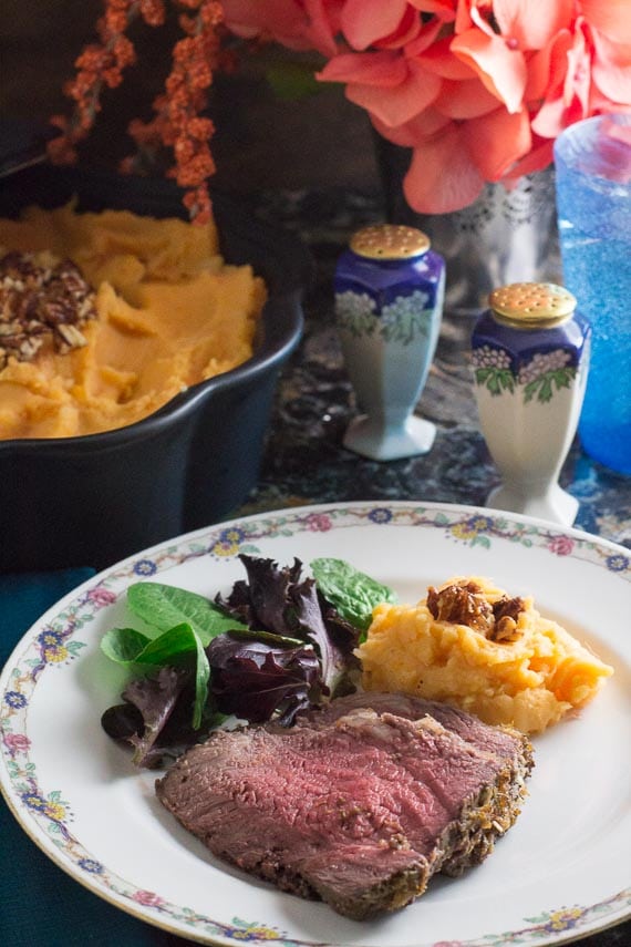 vertical image of Low FODMAP Horseradish Crusted roast Beef, plated with mashed sweet potatoes and salad