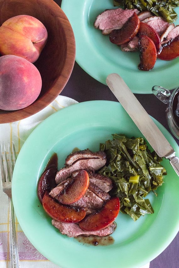 vertical image of Low FODMAP Duck Breasts with Peaches & Red Wine