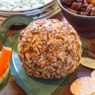 Blue Cheese & Cheddar Cheese Ball on a platter with rice crackers