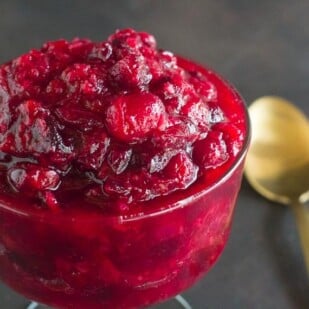 low FODMAP Horseradish cranberry Sauce in a glass dish and gold spoon