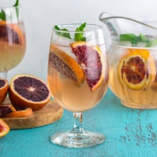 Low FODMAP Blood Orange Ginger Mint Spritzer with pitcher in background