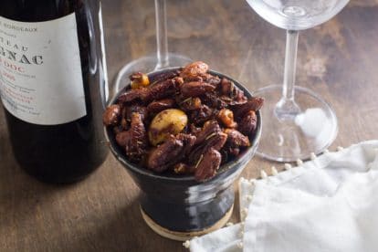 Easy Low FODMAP sweet & spicy nuts in a dark ceramic dish
