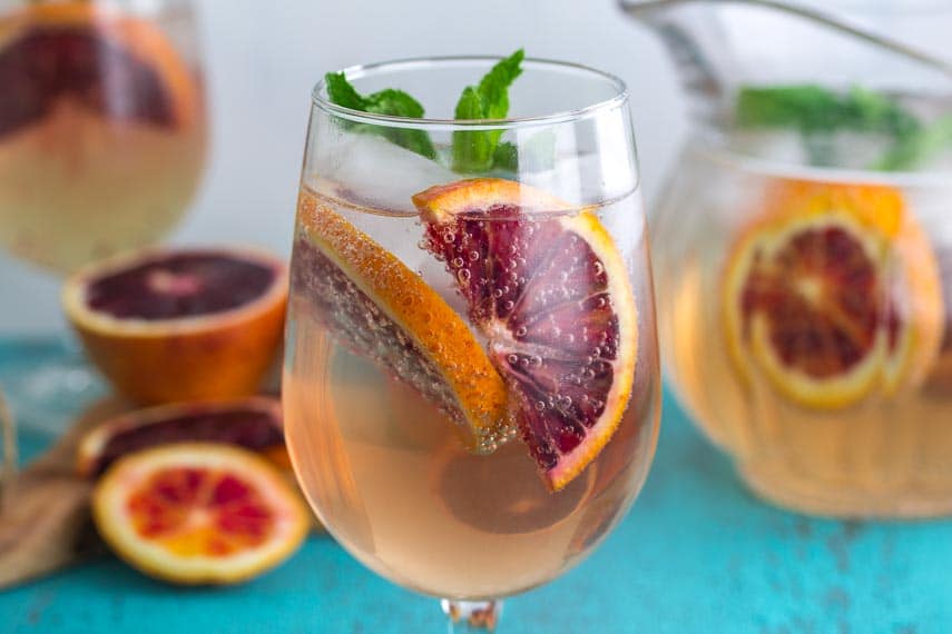 closeup of Low FODMAP Blood Orange Ginger Mint Spritzer in a clear glass