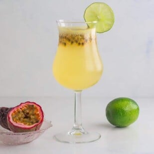 horizontal image of passion for coconut drink with a lime and passion fruit in background