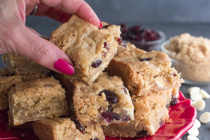 low FODMAP Cranberry white chocolate blondies on red plate-3