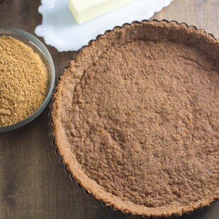 overhead image of a pre-baked low FODMAP crumb crust in a tart pan