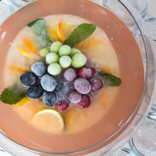 overhead image of punch bowl filled with Low FODMAP Fruited Lemonade Rosé Punch
