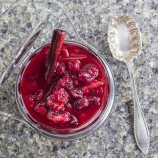 overhead view of Low FODMAP Cranberry Sauce with Orange Marmalade with silver spoon alongside