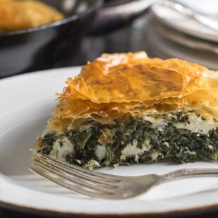 side view of Low FODMAP Spanakopita Spinach Pie on white plate