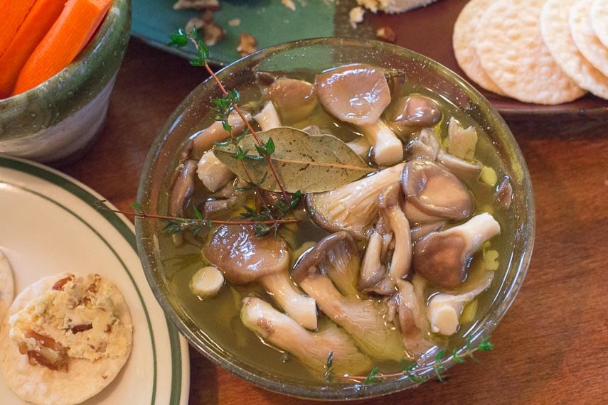 overhead image of easy low FODMAP marinated mushrooms in a glass bowl