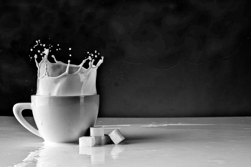 DIY lactose free dairy. Sugar cube dropped in cup of milk