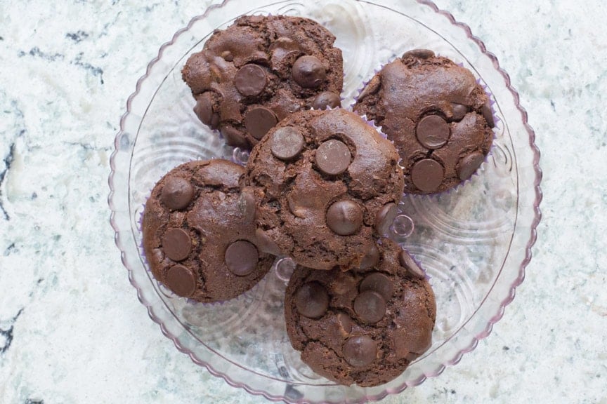 low FODMAP Double Chocolate Muffins on a pink glass plate