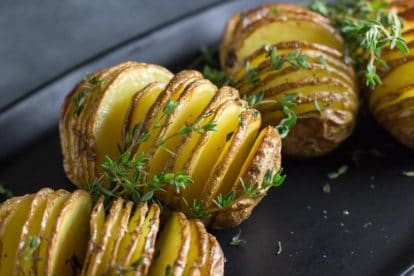 closeup low FODMAP hasselback potatoes with garlic and thyme