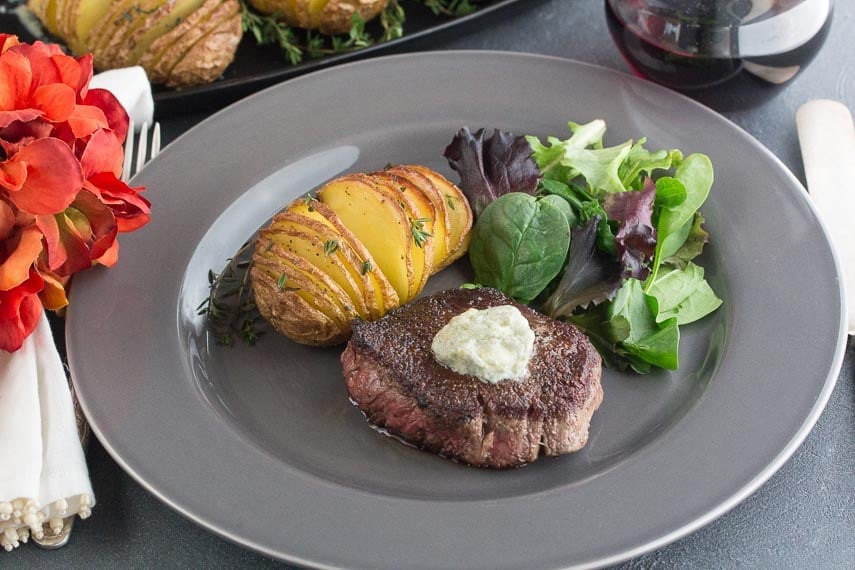 low FODMAP filet mignon medallions with blue cheese compound butter; hasselback potatoes on the side