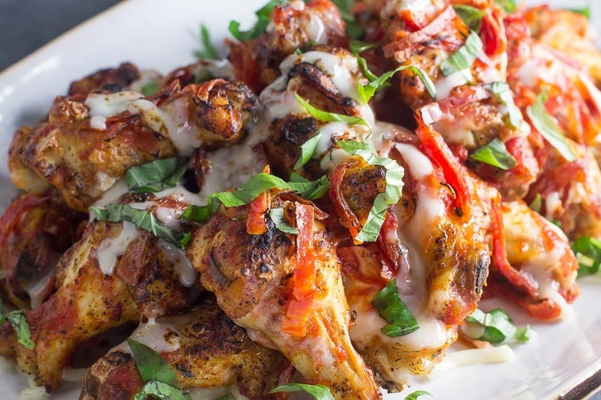 low FODMAP pizza chicken wings closeup on white oval plate