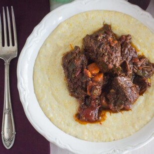 AP short ribs with rosemary and orange on polenta in white bowl